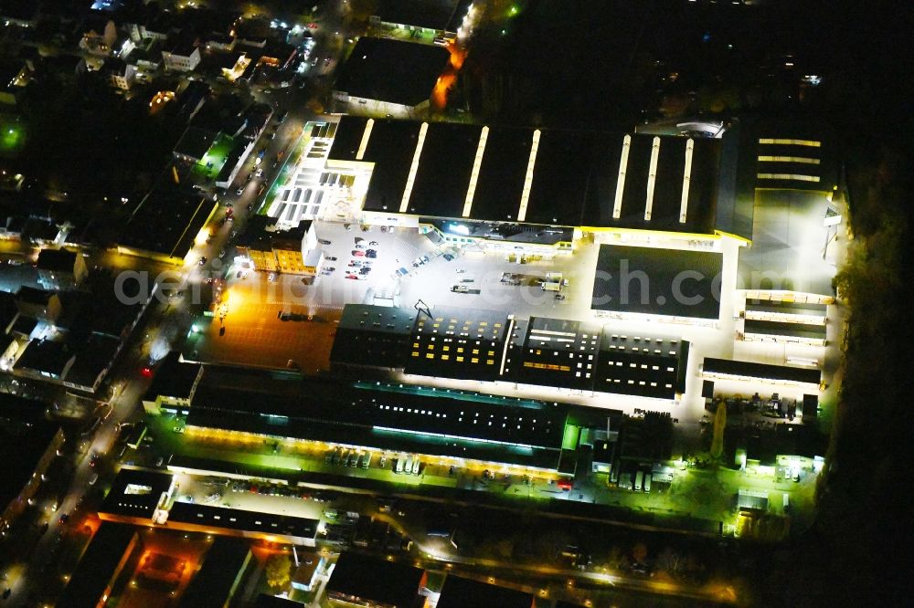 Aerial image at night Berlin - Night lighting Building of the construction market Holz Possling on Haarlemer Strasse in the district Neukoelln in Berlin, Germany