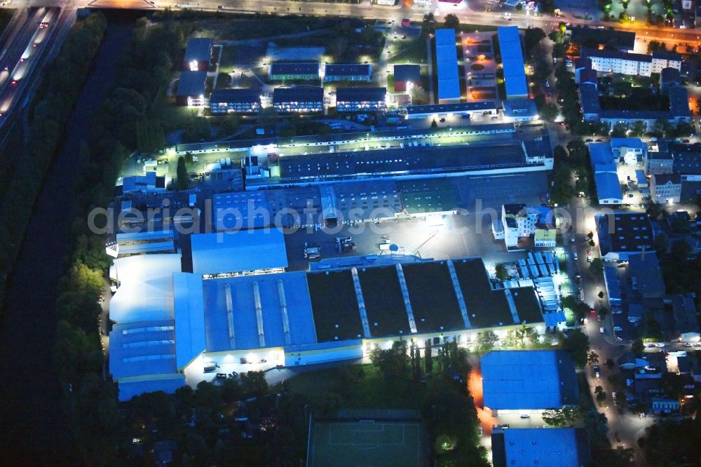 Aerial photograph at night Berlin - Night lighting Building of the construction market Holz Possling on Haarlemer Strasse in the district Neukoelln in Berlin, Germany