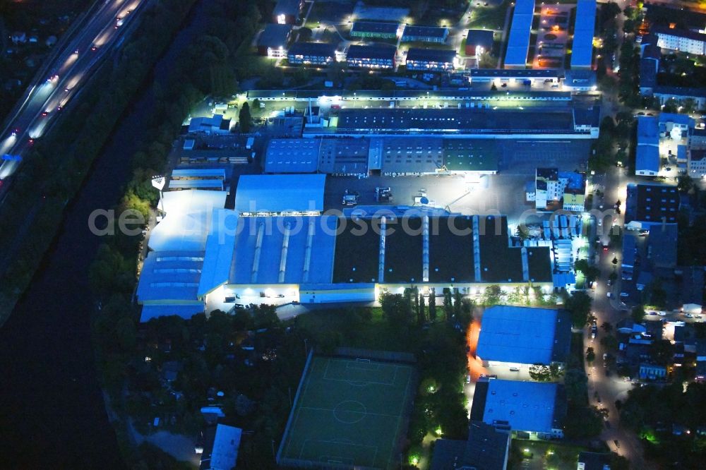 Aerial photograph at night Berlin - Night lighting Building of the construction market Holz Possling on Haarlemer Strasse in the district Neukoelln in Berlin, Germany