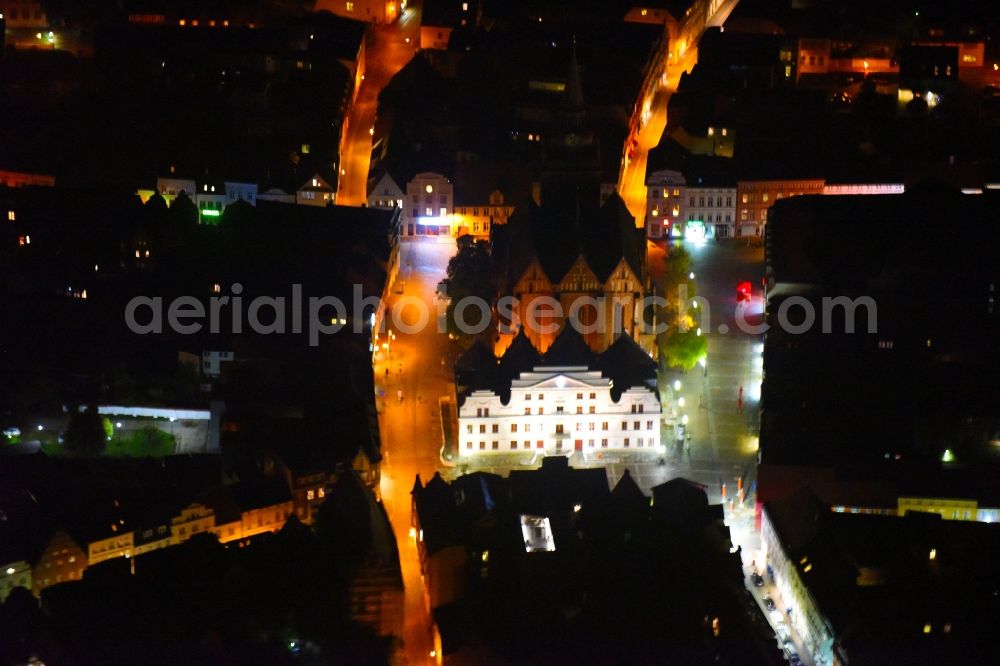 Güstrow at night from above - Night lighting Town Hall building of the City Council at the market downtown in Guestrow in the state Mecklenburg - Western Pomerania, Germany