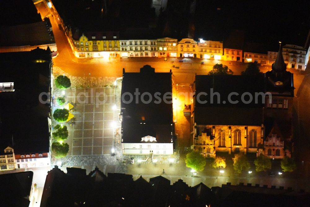 Aerial image at night Güstrow - Night lighting Town Hall building of the City Council at the market downtown in Guestrow in the state Mecklenburg - Western Pomerania, Germany