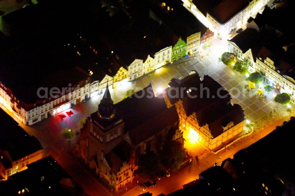 Güstrow at night from above - Night lighting Town Hall building of the City Council at the market downtown in Guestrow in the state Mecklenburg - Western Pomerania, Germany