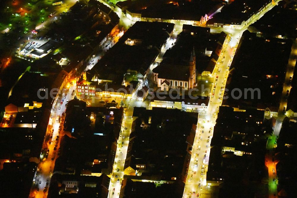 Kyritz at night from the bird perspective: Night lighting Town Hall building of the City Council at the market downtown in Kyritz in the state Brandenburg, Germany