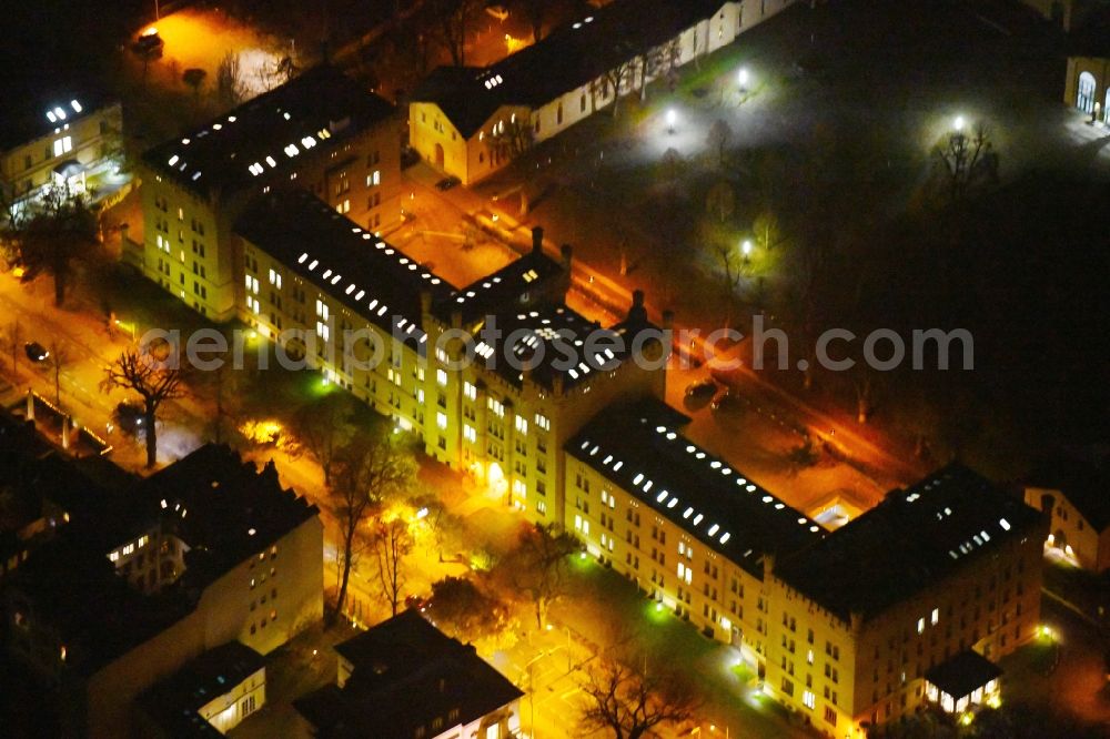 Aerial image at night Potsdam - Night lighting Building complex of the former military barracks Garde-Ulanen-Kaserne in of Jaegerallee in Potsdam in the state Brandenburg, Germany