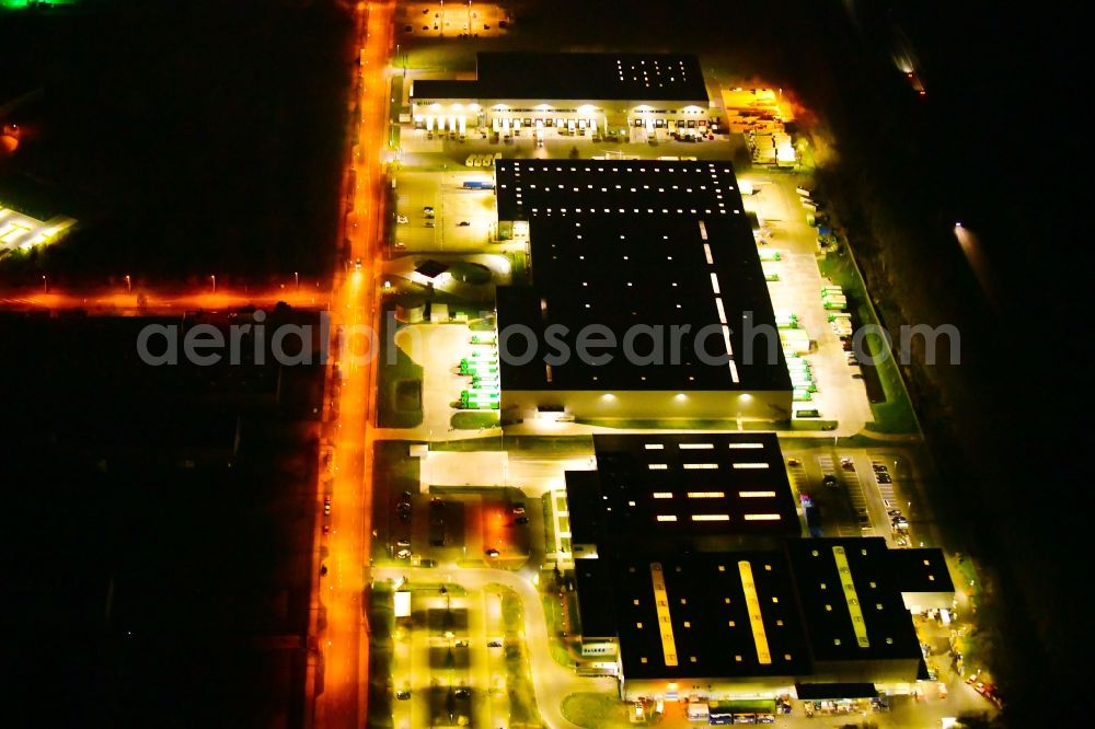 Aerial image at night Wustermark - Night lighting building complex and grounds of the logistics center of Brueof Schlau GmbH & Co. KG in Wustermark in the state Brandenburg, Germany