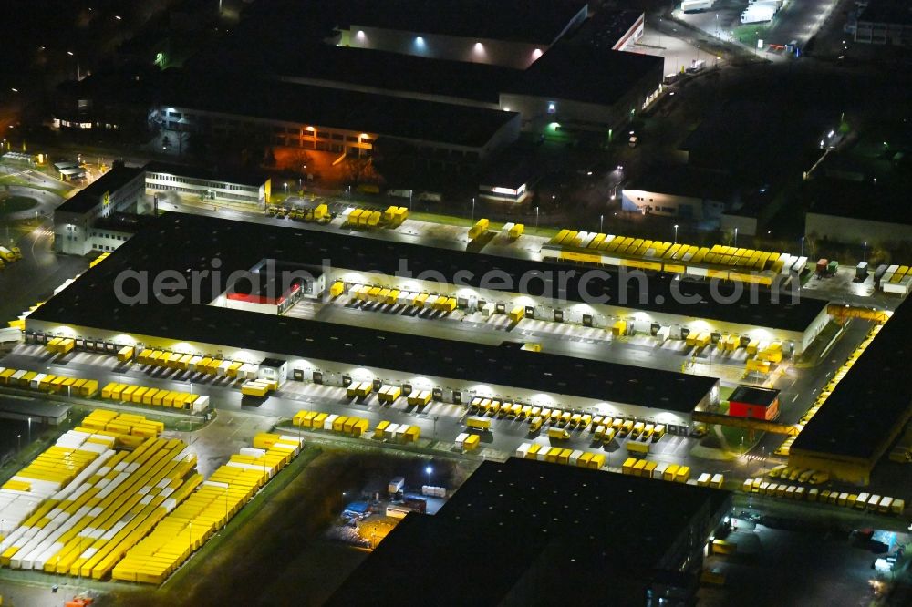 Hamburg at night from the bird perspective: Night lighting building complex and grounds of the logistics center of DHL Paket GmbH on Rungedonm in Hamburg, Germany