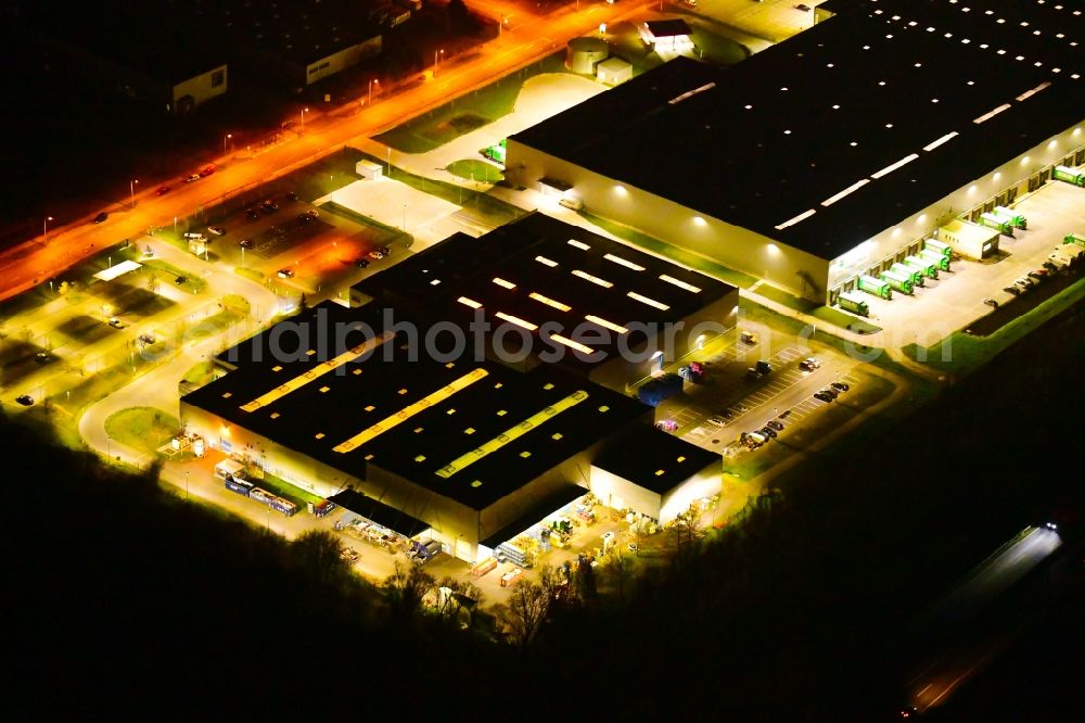 Aerial photograph at night Wustermark - Night lighting building complex and grounds of the logistics center of J&S GmbH Automotive Technology in Wustermark in the state Brandenburg, Germany