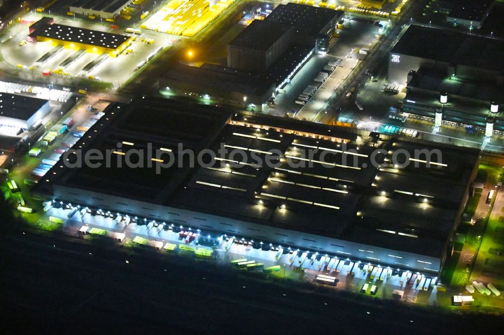 Hamburg at night from above - Night lighting building complex and grounds of the logistics center of H&M Hennes & Mauritz Logistik AB & Co. KG on Rungedonm in Hamburg, Germany