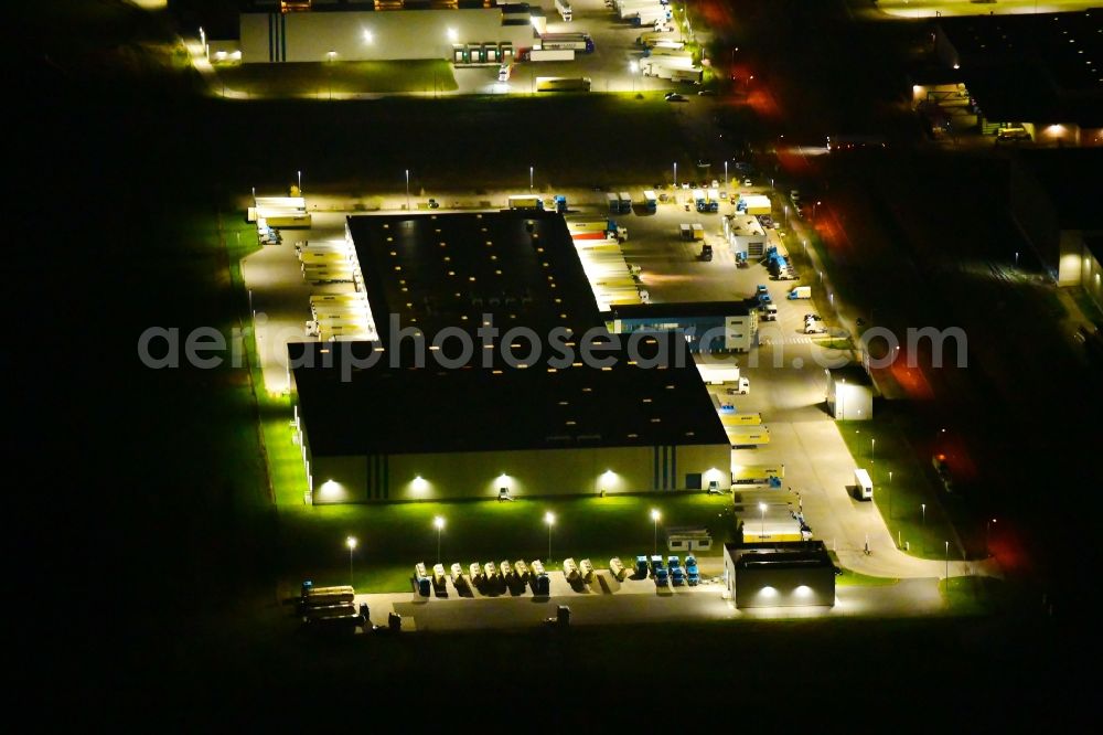 Wustermark at night from above - Night lighting building complex and grounds of the logistics center of Kraftverkehr Nagel SE & Co. KG on Kurt-Nagel-Strasse in Wustermark in the state Brandenburg, Germany