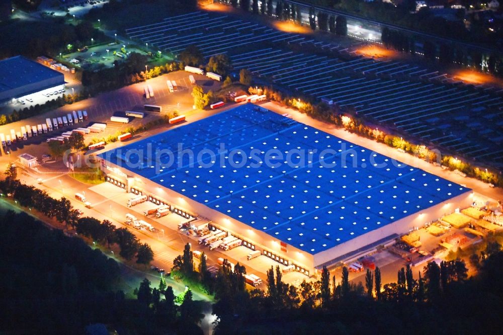 Berlin at night from above - Night lighting building complex and grounds of the logistics center of Rewe Logistik GmbH on Altes Gaswerk Mariendorf in Berlin, Germany