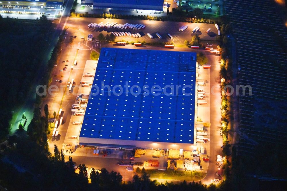 Aerial photograph at night Berlin - Night lighting building complex and grounds of the logistics center of Rewe Logistik GmbH on Altes Gaswerk Mariendorf in Berlin, Germany