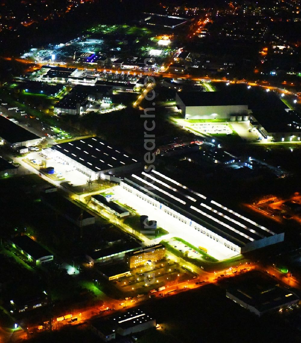 Hoppegarten at night from above - Night lighting Building complex and grounds of the logistics center of Rhenus Home Delivery GmbH in of Industriestrasse in Hoppegarten in the state Brandenburg, Germany