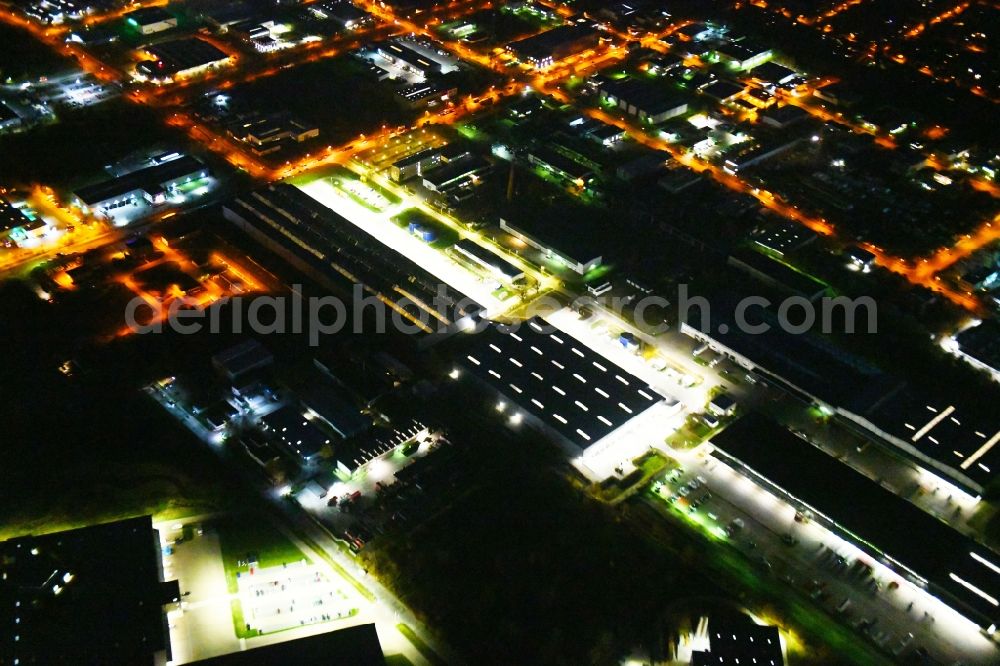 Hoppegarten at night from above - Night lighting Building complex and grounds of the logistics center of Rhenus Home Delivery GmbH in of Industriestrasse in Hoppegarten in the state Brandenburg, Germany