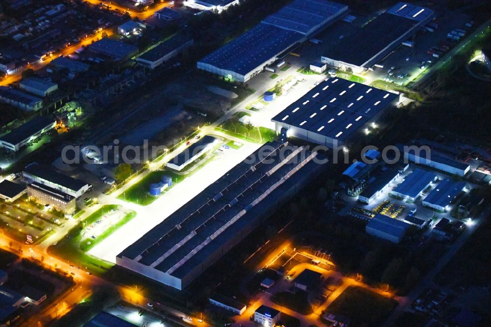 Aerial image at night Hoppegarten - Night lighting Building complex and grounds of the logistics center of Rhenus Home Delivery GmbH in of Industriestrasse in Hoppegarten in the state Brandenburg, Germany