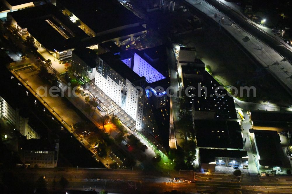 Aerial photograph at night Berlin - Night lighting Complex of the hotel building Estrel Berlin in the district Neukoelln in Berlin, Germany