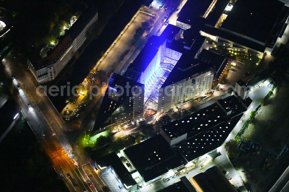 Aerial image at night Berlin - Night lighting Complex of the hotel building Estrel Berlin in the district Neukoelln in Berlin, Germany