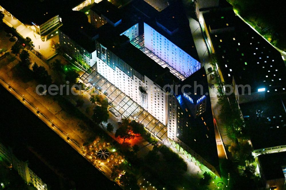 Aerial image at night Berlin - Night lighting Complex of the hotel building Estrel Berlin in the district Neukoelln in Berlin, Germany