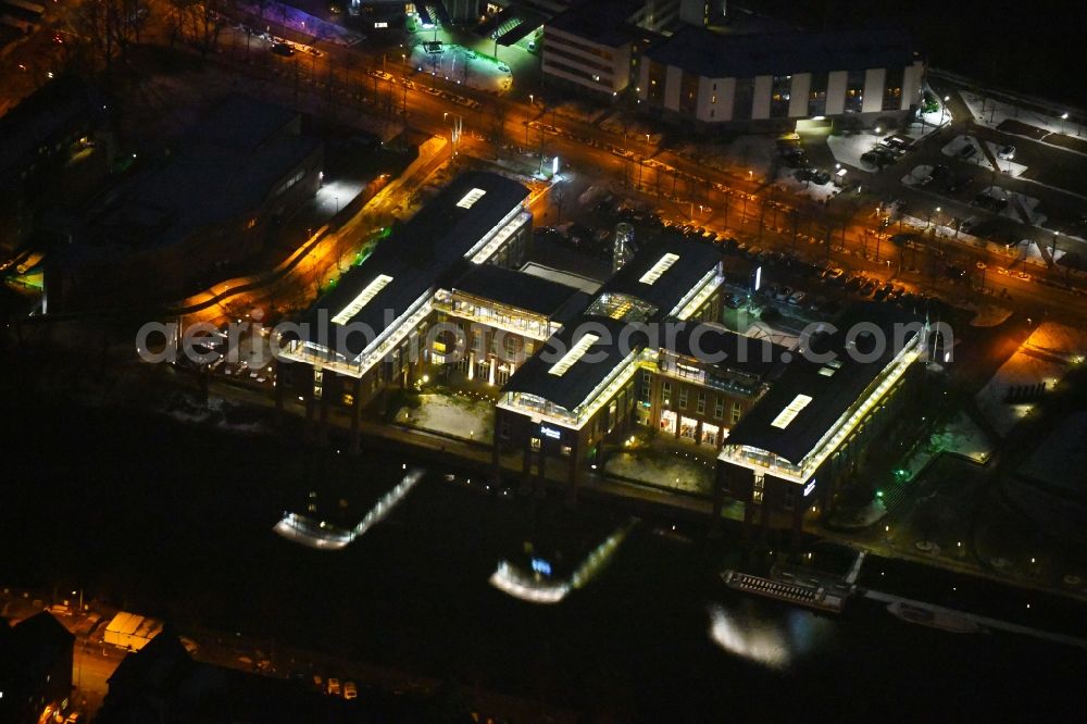 Aerial image at night Lübeck - Night lighting complex of the hotel building Radisson Blu Senator Hotel on Luebeck Willy-Brandt-Allee in the district Innenstadt in Luebeck in the state Schleswig-Holstein, Germany