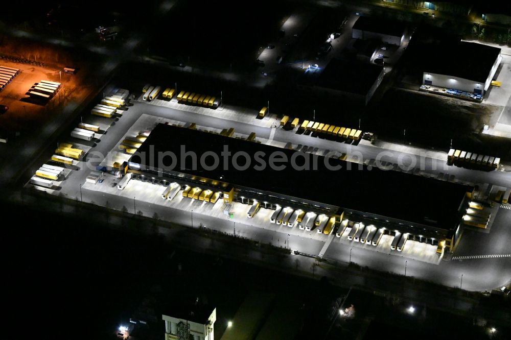 Aerial photograph at night Thörey - Night lighting building complex and distribution center on the site of DACHSER SE in Thoerey in the state Thuringia, Germany