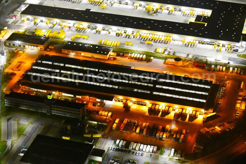 Leipzig at night from the bird perspective: Night lighting Building complex and distribution center on the site of DHL - Deutsche Post AG on Poststrasse in the district Nordwest in Leipzig in the state Saxony, Germany