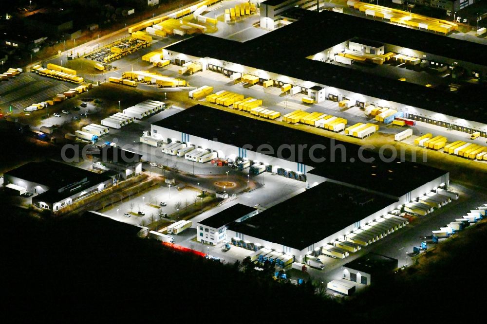 Nürnberg at night from the bird perspective: Night lighting building complex and distribution center on the site der DHL im Gewerbepark Nuernberg-Feucht in Nuremberg in the state Bavaria