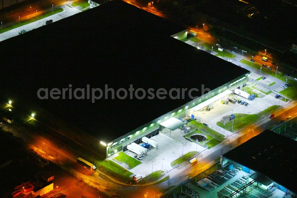 Leipzig at night from above - Night lighting Building complex and distribution center on the site of Faurecia Emissions Control Technologies Germany GmbH on Seilerweg in Leipzig in the state Saxony, Germany