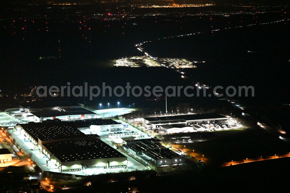 Aerial image at night Schleinitz - Night lighting building complex and distribution center on the site Kaufland Logistik VZ GmbH & Co. KG - Osterfeld on street Kirchweg in Schleinitz in the state Saxony-Anhalt, Germany