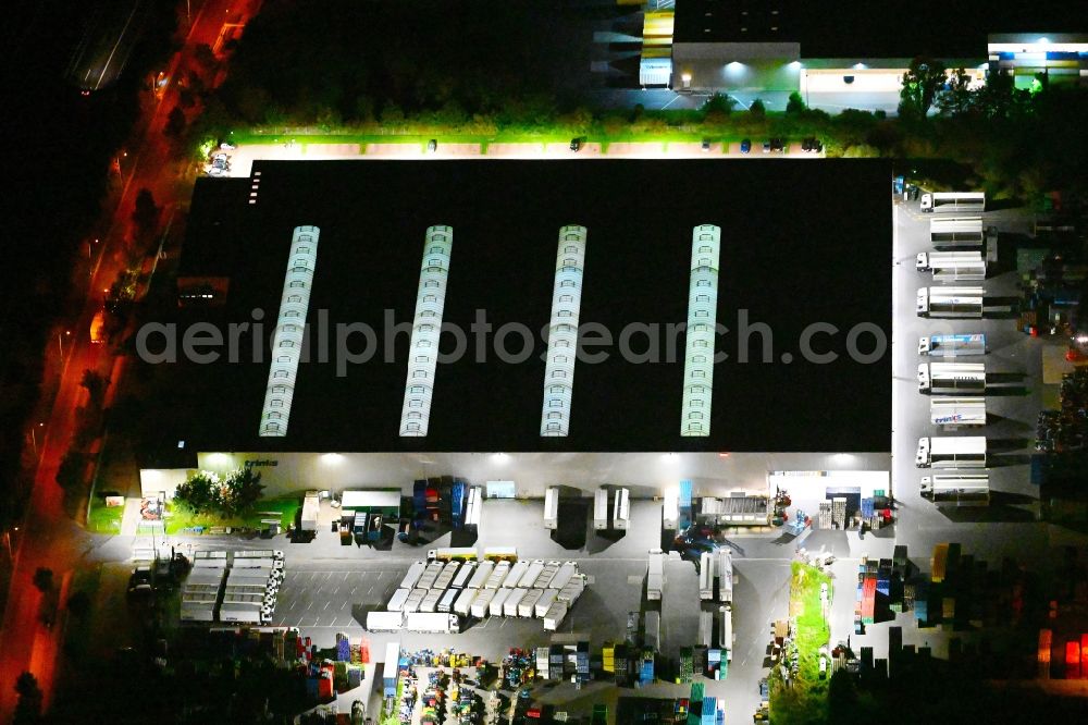 Aerial image at night Großbeeren - Night lighting building complex and distribution center on the site der Trinks GmbH on street Maerkische Allee in Grossbeeren in the state Brandenburg, Germany