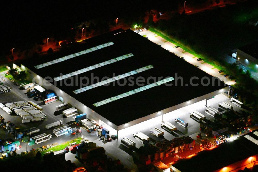 Großbeeren at night from above - Night lighting building complex and distribution center on the site der Trinks GmbH on street Maerkische Allee in Grossbeeren in the state Brandenburg, Germany