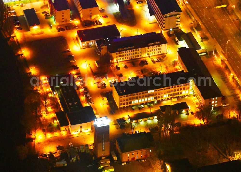 Aerial image at night Berlin - Night lighting Building complex of the police Bundespolizeidirektion in the district Niederschoeneweide in Berlin