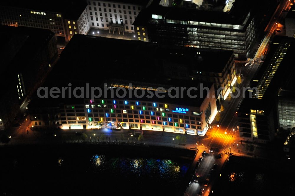 Berlin at night from above - Night lighting complex of buildings with satellite dishes on the transmitter broadcasting center ARD - Hauptstadtstudio on street Wilhelmstrasse - Reichstagufer - Dorotheenstrasse in the district Mitte in Berlin, Germany