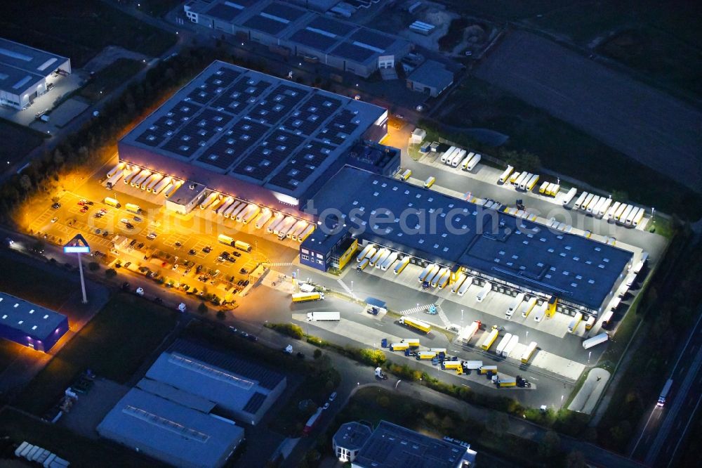 Aerial image at night Dissen am Teutoburger Wald - Night lighting Building complex and distribution center on the site of Dachser SE Food Logistics on Konpweg in Dissen am Teutoburger Wald in the state Lower Saxony, Germany