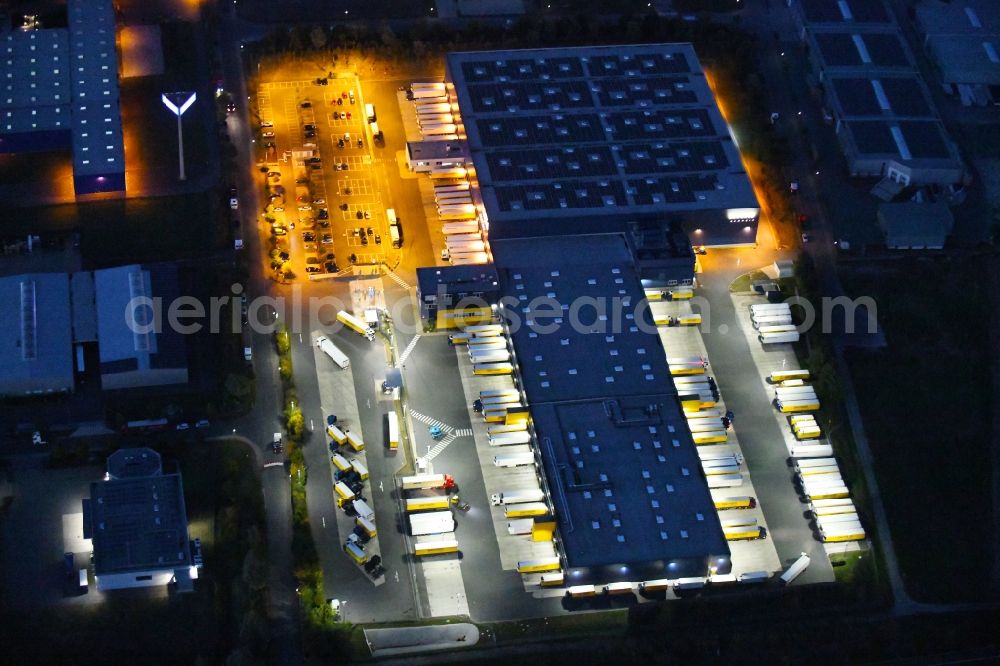 Aerial photograph at night Dissen am Teutoburger Wald - Night lighting Building complex and distribution center on the site of Dachser SE Food Logistics on Konpweg in Dissen am Teutoburger Wald in the state Lower Saxony, Germany