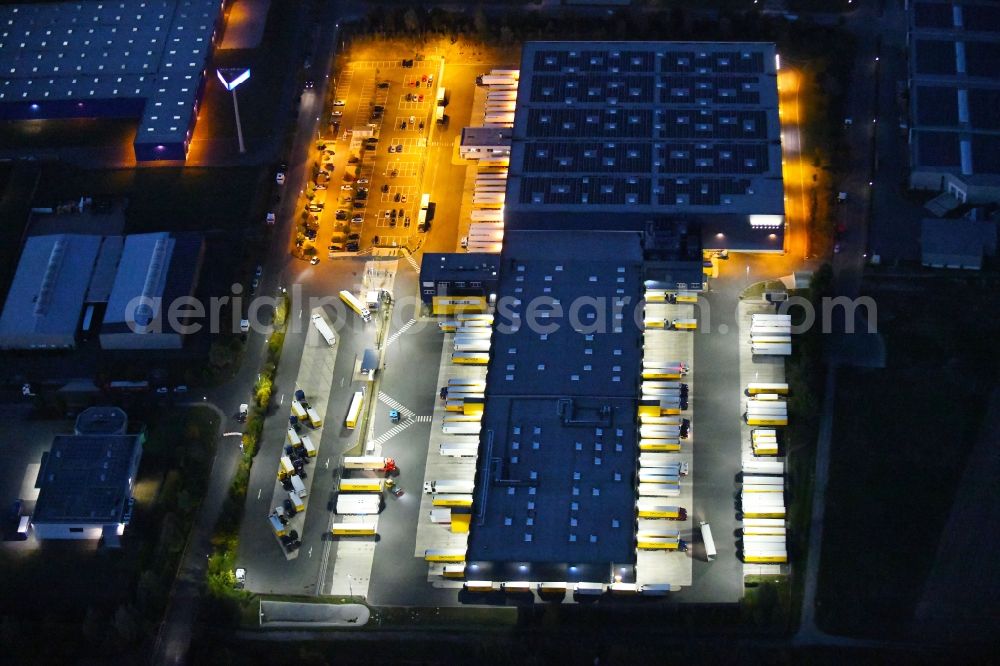 Dissen am Teutoburger Wald at night from above - Night lighting Building complex and distribution center on the site of Dachser SE Food Logistics on Konpweg in Dissen am Teutoburger Wald in the state Lower Saxony, Germany