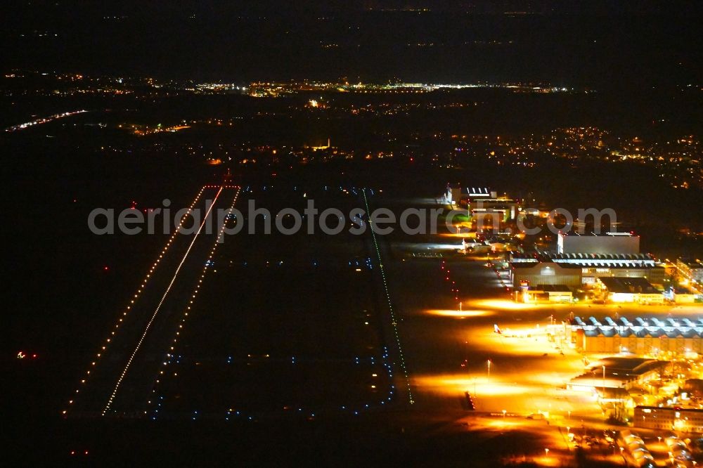 Dresden at night from above - Night lighting Runway with hangar taxiways and terminals on the grounds of the airport in the district Klotzsche in Dresden in the state Saxony, Germany