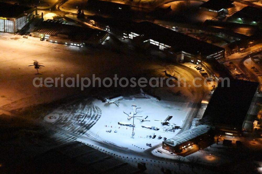 Schönefeld at night from above - Night view wintry snowy hangar taxiways and terminals on the grounds of the airport GAT in the district Schoenefeld in Schoenefeld in the state Brandenburg