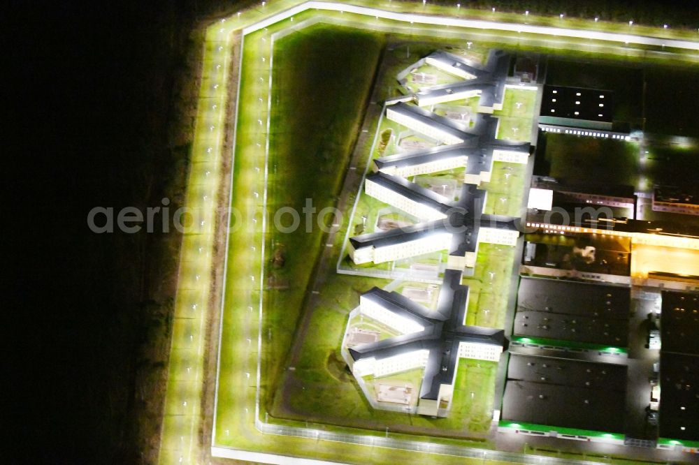 Aerial image at night Burg - Night lighting prison grounds and high security fence Prison in Burg in the state Saxony-Anhalt