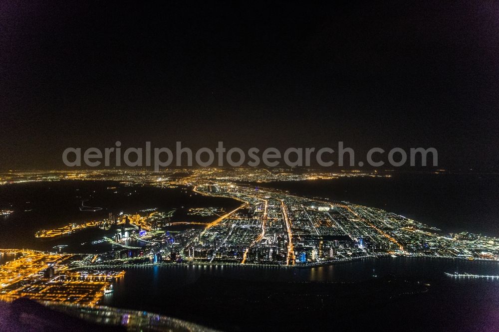 Abu Dhabi at night from above - Night lighting City area with outside districts and inner city area in Abu Dhabi in United Arab Emirates