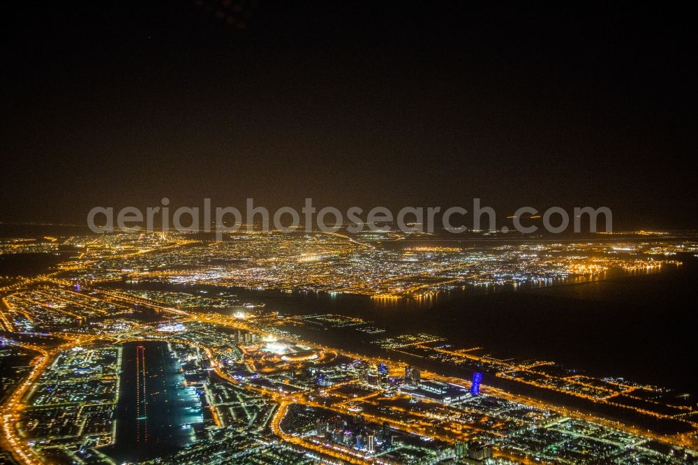 Abu Dhabi at night from the bird perspective: Night lighting City area with outside districts and inner city area in Abu Dhabi in United Arab Emirates