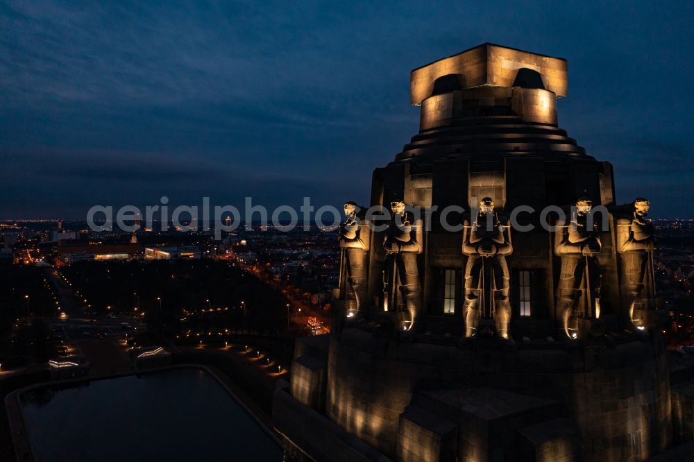 Aerial photograph at night Leipzig - Night lighting Tourist attraction of the historic monument Voelkerschlachtdenkmal on Strasse of 18. Oktober in Leipzig in the state Saxony, Germany