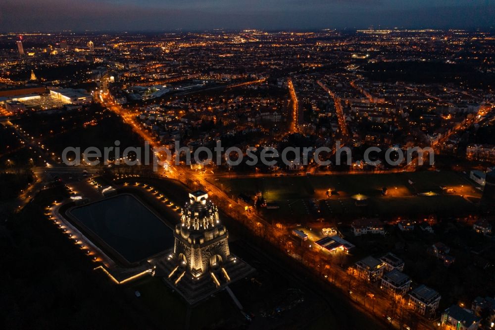 Aerial image at night Leipzig - Night lighting Tourist attraction of the historic monument Voelkerschlachtdenkmal on Strasse of 18. Oktober in Leipzig in the state Saxony, Germany