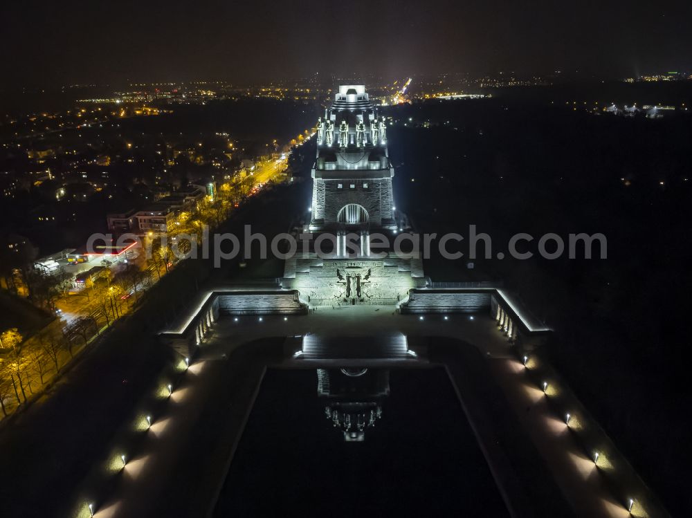 Aerial photograph at night Leipzig - Night lighting tourist attraction of the historic monument Voelkerschlachtdenkmal on Strasse of 18. Oktober in Leipzig in the state Saxony, Germany