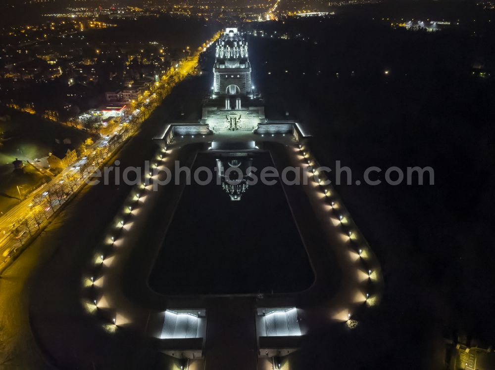 Aerial image at night Leipzig - Night lighting tourist attraction of the historic monument Voelkerschlachtdenkmal on Strasse of 18. Oktober in Leipzig in the state Saxony, Germany