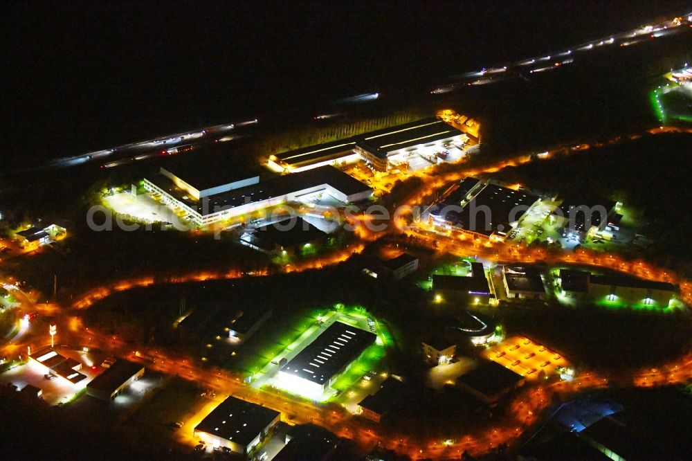 Aerial image at night Ludwigsfelde - Night lighting Industrial estate and company settlement of Brandenburg Park Immobilien GmbH in Ludwigsfelde in the state Brandenburg, Germany