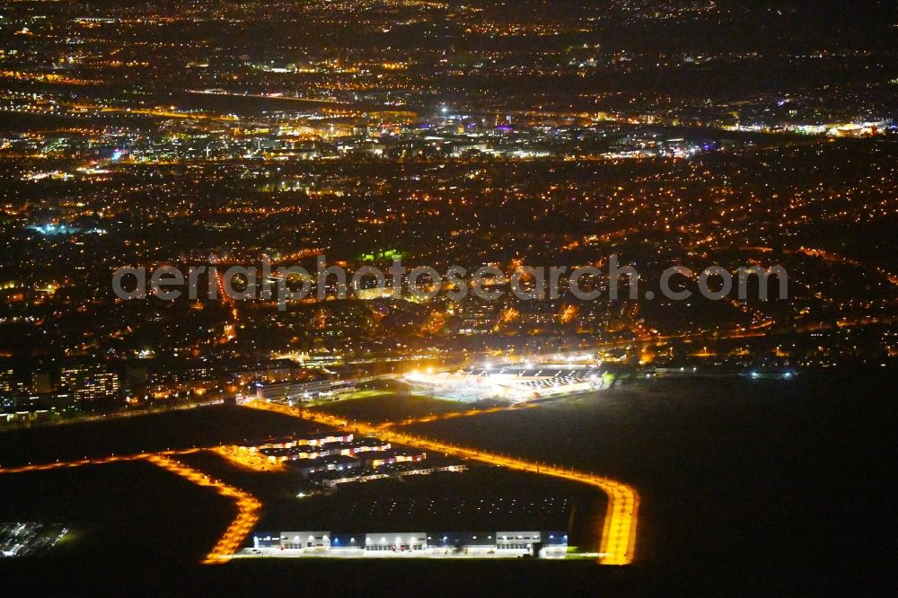 Berlin at night from the bird perspective: Night lighting Industrial estate and company settlement Business Park Berlin on Alexander-Meissner-Strasse in Berlin, Germany