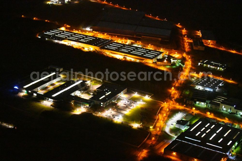 Aerial image at night Hörselberg-Hainich - Night lighting Industrial estate and company settlement along the Industriestrasse in the district Grossenlupnitz in Hoerselberg-Hainich in the state Thuringia, Germany