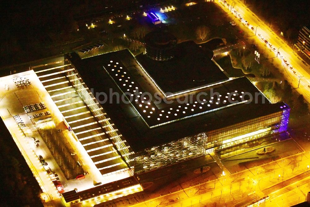 Aerial photograph at night Dresden - Night lighting vW transparent factory in Dresden in Saxony. The transparent factory is a Dresden automobile factory of Volkswagen AG, which is operated by the Volkswagen Sachsen GmbH