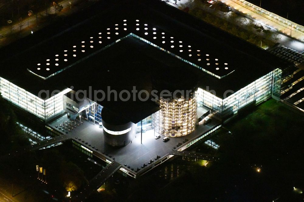 Aerial image at night Dresden - Night lighting vW transparent factory in Dresden in Saxony. The transparent factory is a Dresden automobile factory of Volkswagen AG, which is operated by the Volkswagen Sachsen GmbH