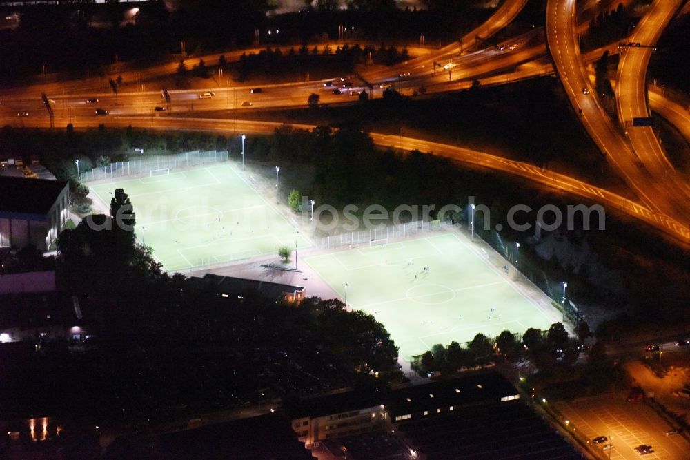 Berlin at night from the bird perspective: Night view green colored tennis sports complex aloung highway A100 destrict Neukoelln in Berlin