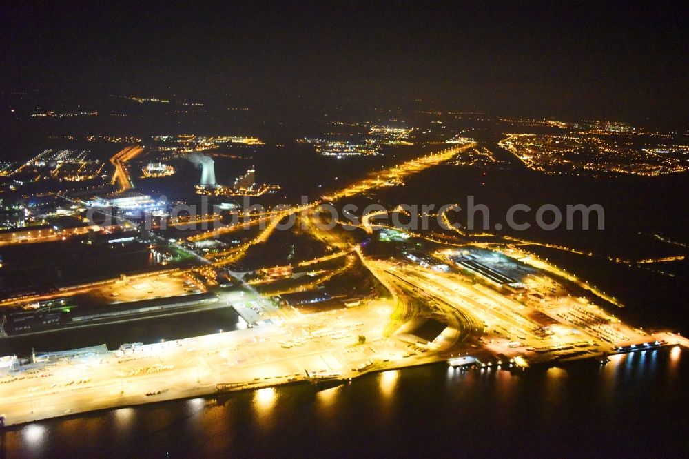 Rostock at night from above - Night lighting Port facilities on the shores of the harbor of Faehrterminal in Rostock in the state Mecklenburg - Western Pomerania, Germany